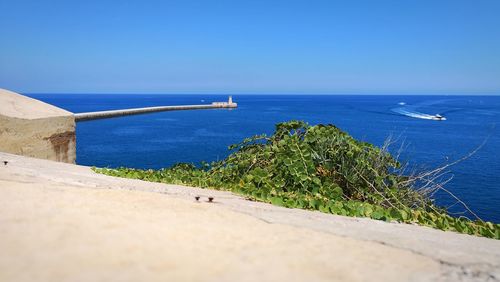 Scenic view of sea against clear blue sky