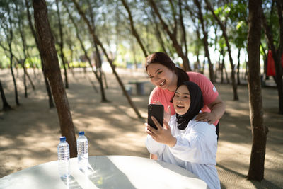 Side view of young woman standing in park