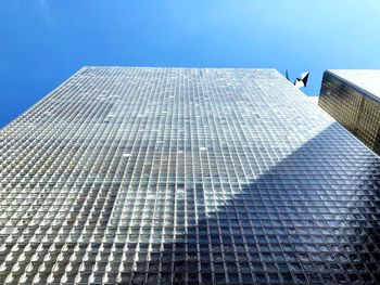 Low angle view of modern building against clear blue sky