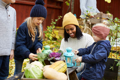 Smiling female with children in yard