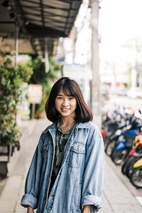 Portrait of smiling woman in city