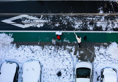 People on snow covered pool during winter