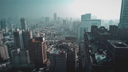 High angle view of modern buildings in city against sky