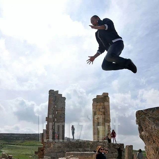 lifestyles, leisure activity, sky, full length, men, cloud - sky, low angle view, mid-air, cloudy, jumping, young men, cloud, risk, photography themes, activity, skill, casual clothing