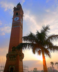 Low angle view of tower against sky at sunset