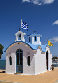 Greece flag on church against sky