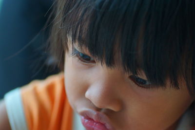 Close-up of cute boy looking away