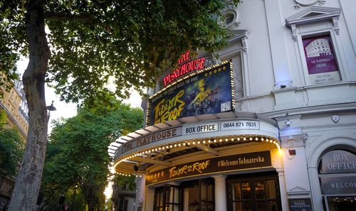 Low angle view of illuminated sign against building