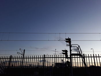 Low angle view of silhouette bridge against sky during sunset