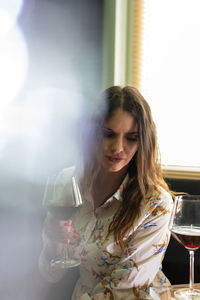 Young woman drinking water from glass