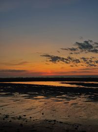 Scenic view of beach against sky during sunset