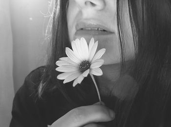 Cropped image of woman holding flower