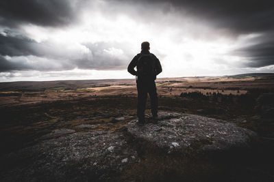 Rear view of man standing on dartmoor tor