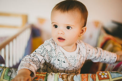 Close-up portrait of baby girl at home