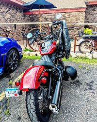 Man riding motor scooter parked on road