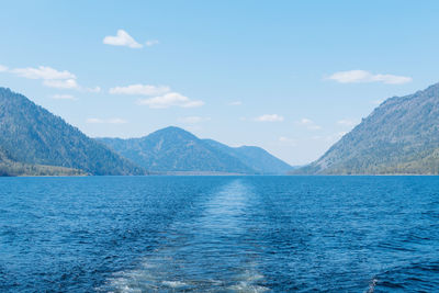 Scenic view of sea and mountains against sky