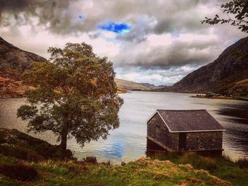 Scenic view of lake by building against sky