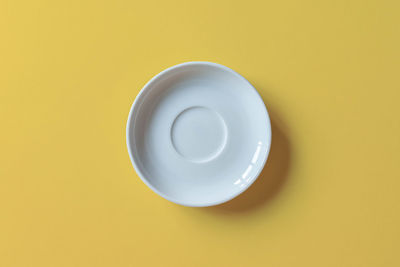 Directly above shot of empty tea over yellow background