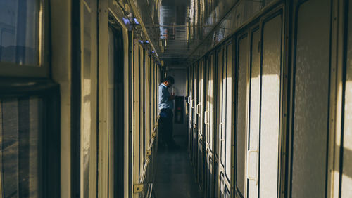 Man standing in corridor of building