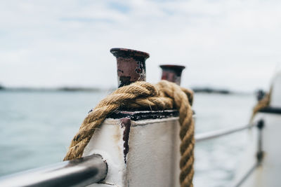 Close-up of rope tied to post of boat