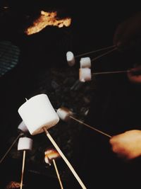 Close-up of hand holding candles