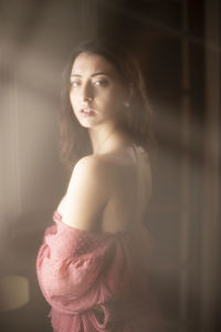 Portrait of beautiful young woman standing at home