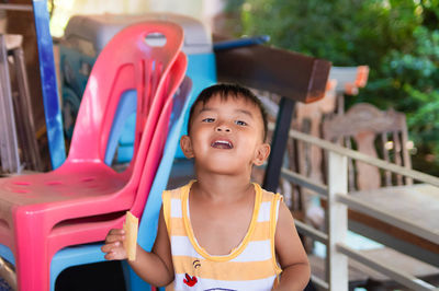 Portrait of cute boy sitting outdoors