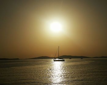 View of sailboat in sea at sunset