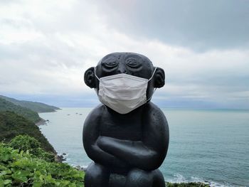 Statue against sea and sky