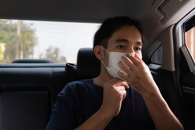 Portrait of man sitting in car