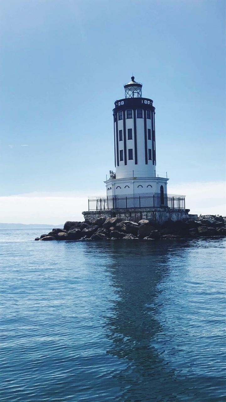 lighthouse, sea, water, architecture, waterfront, guidance, sky, built structure, horizon over water, tranquility, tranquil scene, nature, no people, beauty in nature, building exterior, scenics, blue, outdoors, day