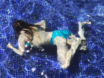 Young woman swimming in pool