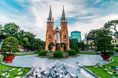 Fountain in front of building against sky