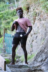 Portrait of man standing on rock