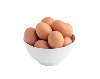 Close-up of eggs against white background