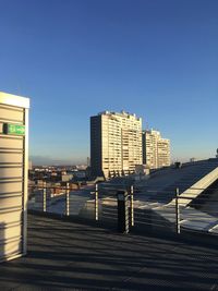 Modern buildings in city against clear blue sky