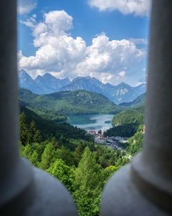 Scenic view of river and mountains against sky