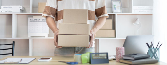 Midsection of man holding parcels