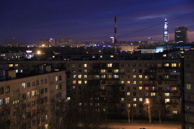 Illuminated cityscape against sky at night