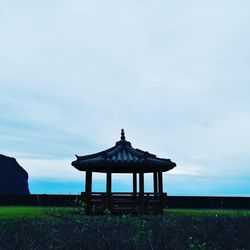 Gazebo on field against sky