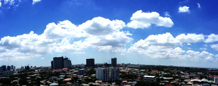 Buildings against cloudy sky