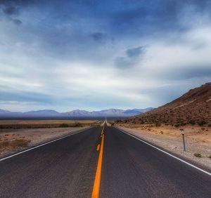 Road by landscape against sky