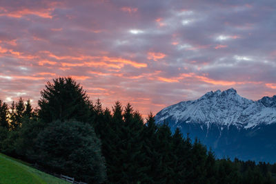 Scenic view of snowcapped mountains against sky during sunset