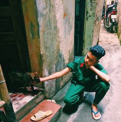 Young woman sitting on wall