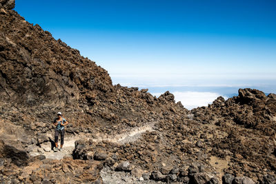 Girl walking on a trail on a volcano
