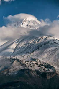 Aerial view of snowcapped mountains against sky