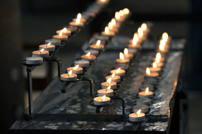 Candles burning in illuminated building
