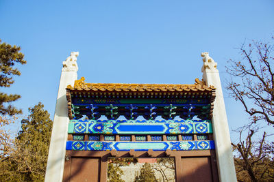 Low angle view of temple against clear blue sky