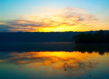 Scenic view of lake against romantic sky at sunset