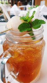 Close-up of lychee tea in jar on table